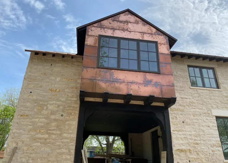 Copper metal panel facade on a stone building for Skylight Installation in Yulee