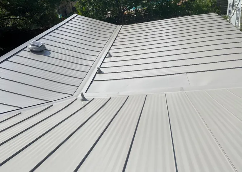 Solar attic fan installed on a metal roof for Roof Ventilation in Yulee
